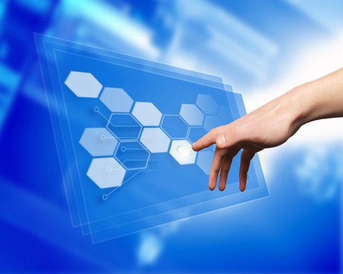 Hands adjusting the brightness level on a computer monitor